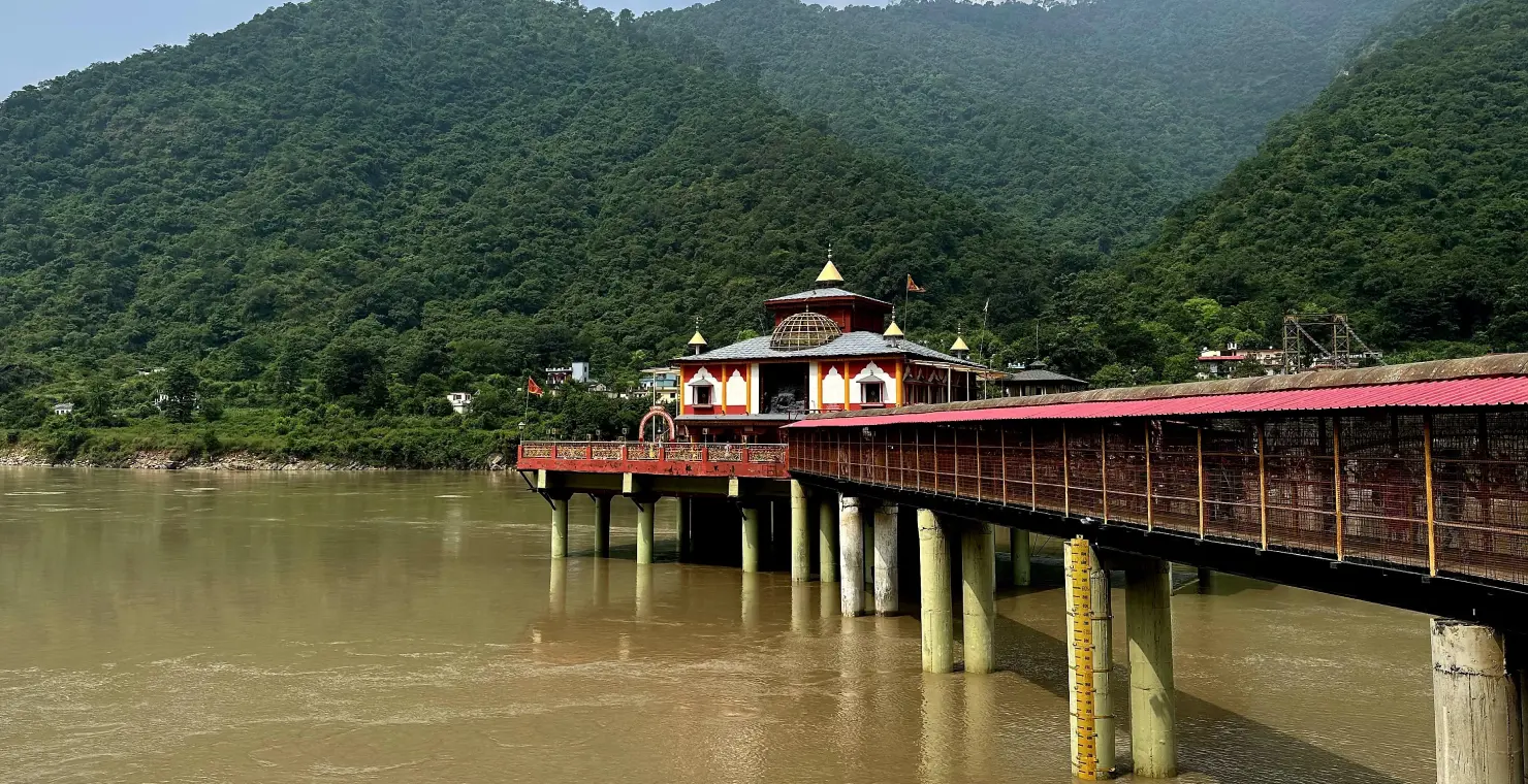 Scenic view of Dhari Devi Temple over the Alaknanda River surrounded by lush green hills